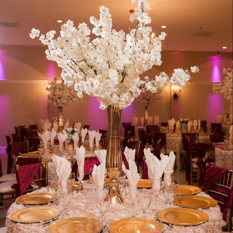 Villa Tuscana Reception Hall event showing large white floral centerpiece table decoration