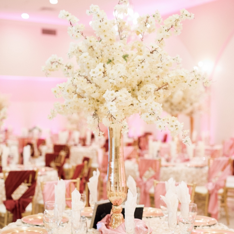 Villa Tuscana Reception Hall event showing Large white floral table centerpeice