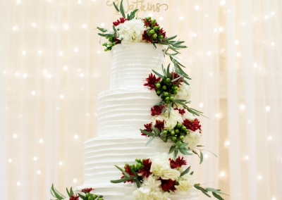 White tiered wedding cake with cascading flowers