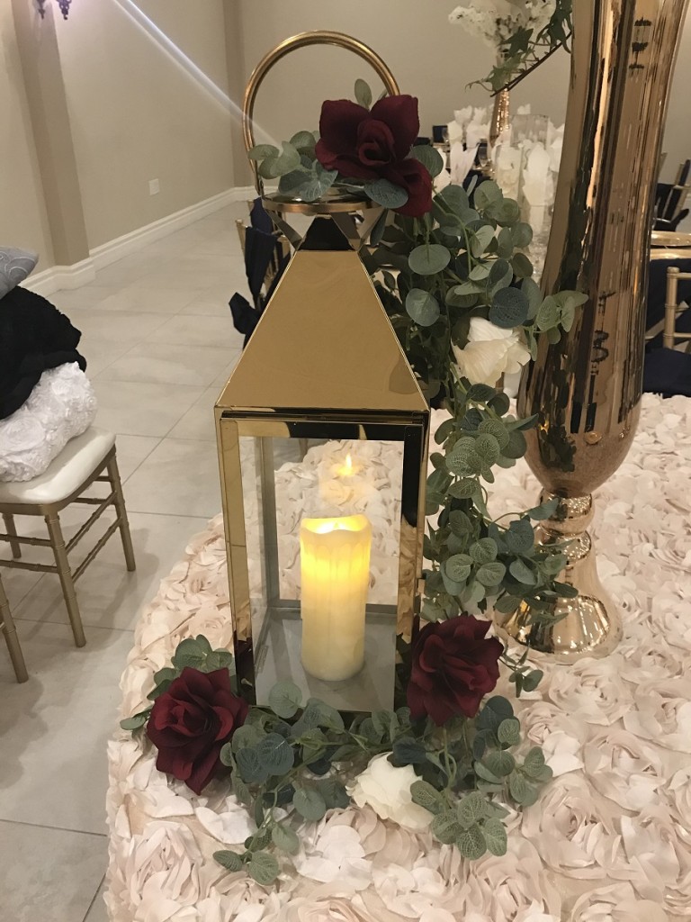 Custom wedding centerpiece with candles and florals in the Villa Tuscana ballroom