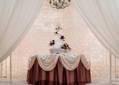 Villa Tuscana Reception Hall in mesa showing tied wedding cake in reception area on custom decorated table