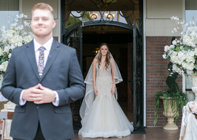 Villa Tuscana Reception Hall in mesa showing bride walking behind groom