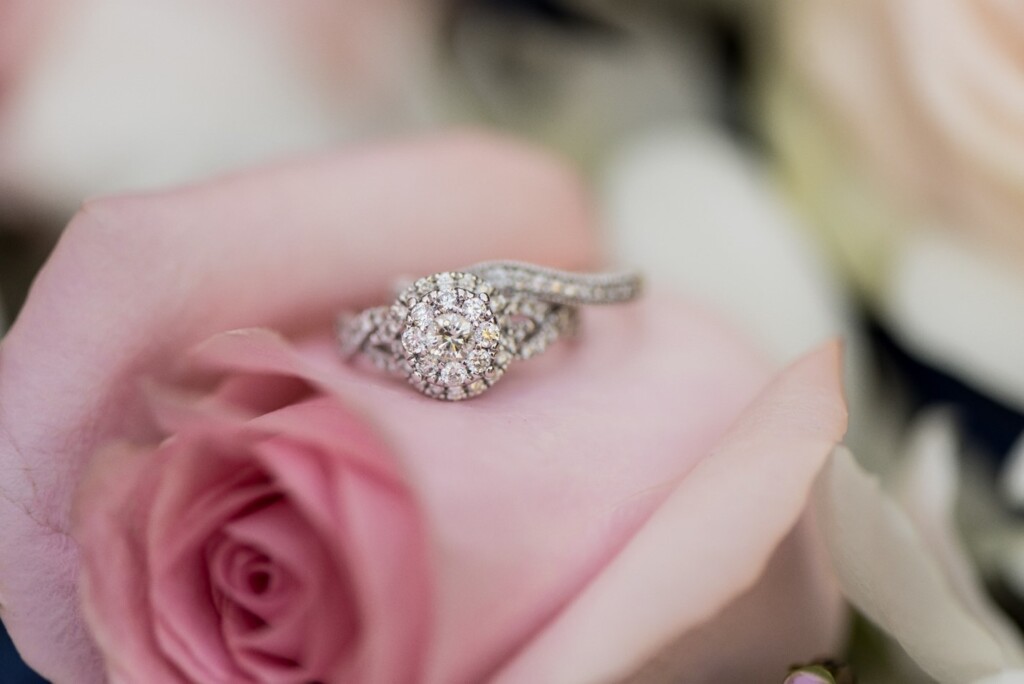 Wedding rings photographed with the invitation suite and florals