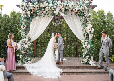 Villa Tuscana Reception Hall in mesa showing bride and groom kissing at altar