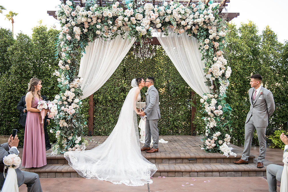 Villa Tuscana Reception Hall in mesa showing bride and groom kissing at altar